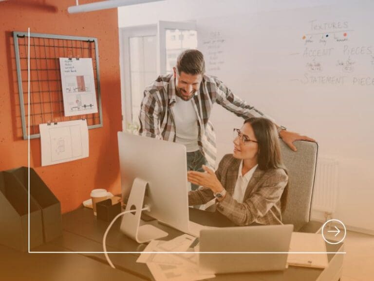 Two coworkers are looking at computer screen, leadership concept