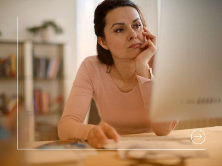 Bored woman looking at a computer while working from home, failure concept