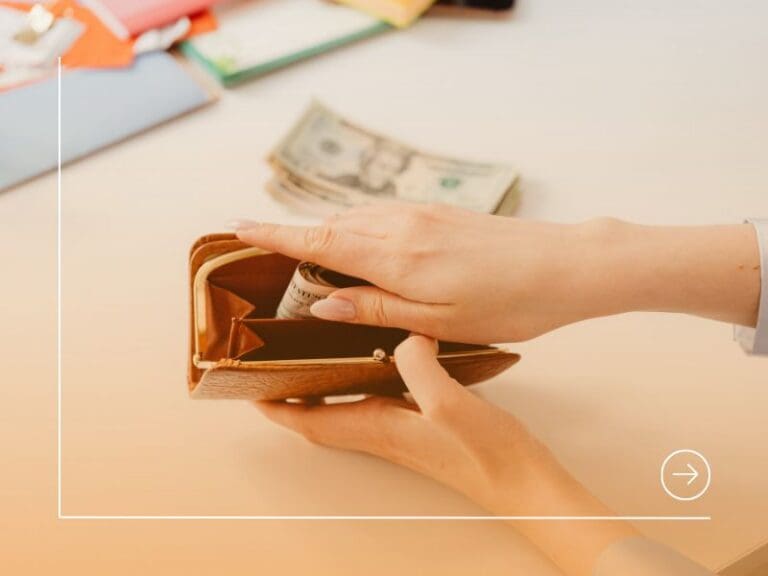 Person Putting Money in a Brown Wallet