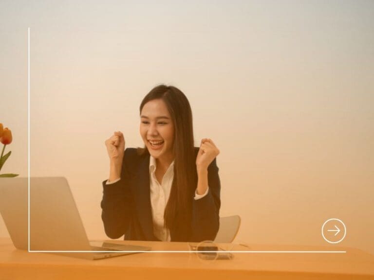 Portrait of a Young attractive Asian woman in a black business suit feeling euphoric celebration online win success achievement result. Quiet achiever concept