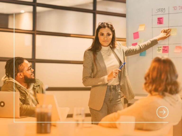 Scrum master engaging her business team in effective project management during a meeting, project manager