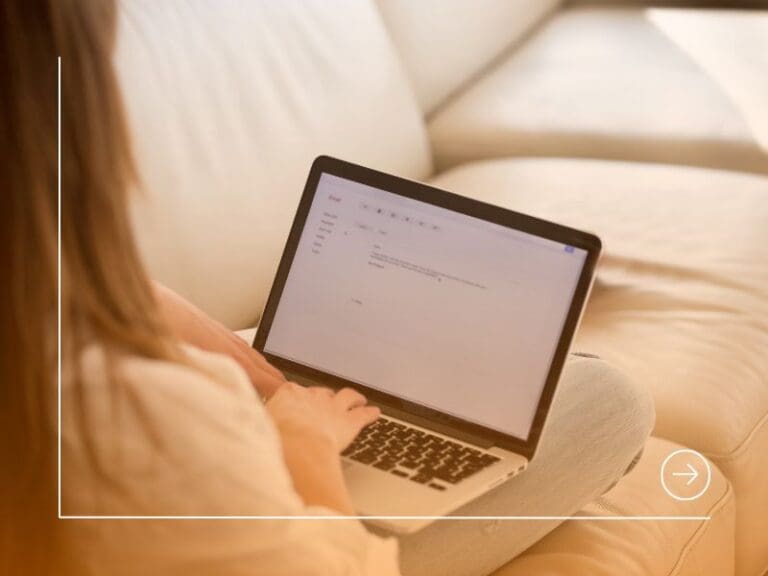 Rear view at woman writing email on laptop at home, cover letter concept