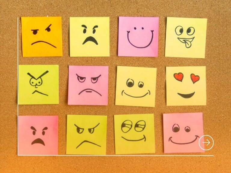 post-it notes with different face expression on cork board, emotions at work concept